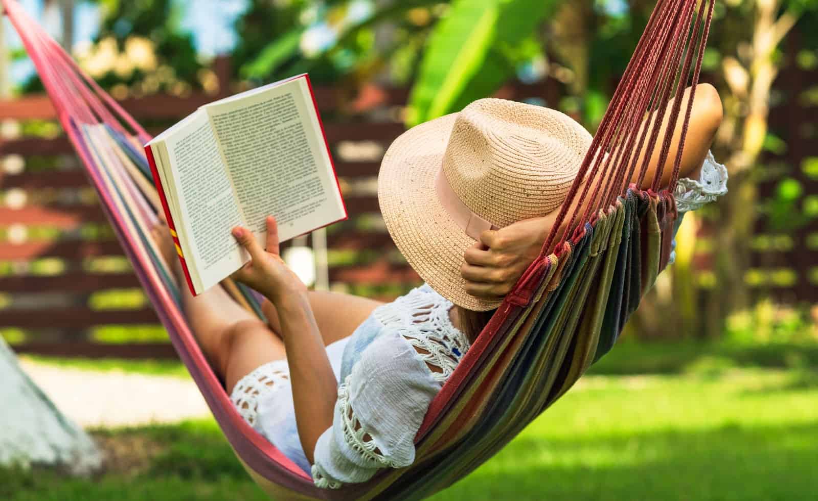 Summer Reading List for Adults: 50 Amazing Books to Take to the Beach 2 woman reading during the summer in a hammock