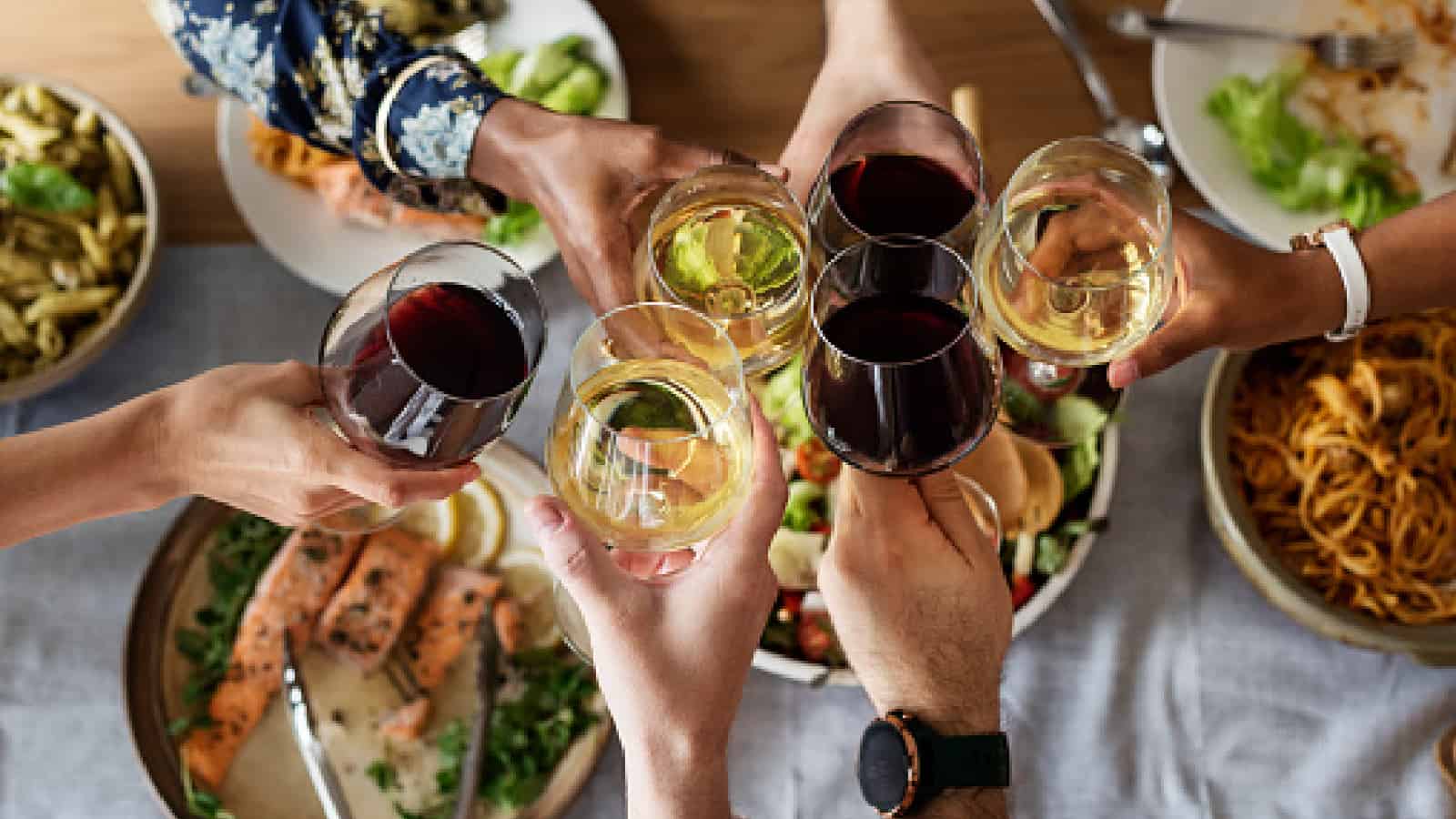 Friends gathering having Italian food together with tasty wine pairings